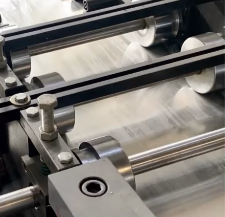 Aluminum passing through a tandem rolling mill on the production line