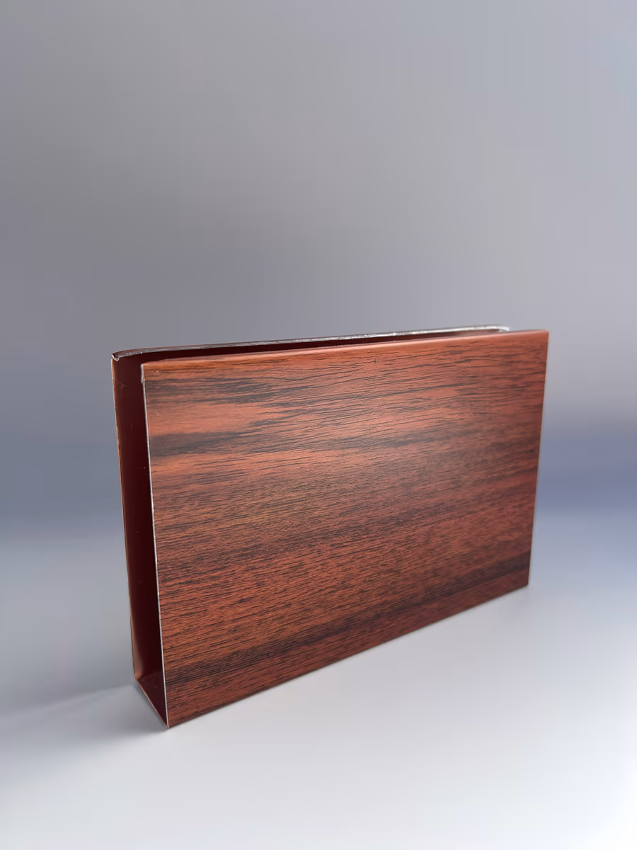 Cut sample of a 1"x4" cold-rolled aluminum baffle in a dark wood grain finish