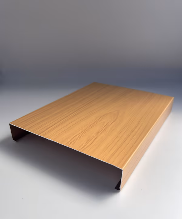 Cut sample of a 6" wide H-shaped aluminum strip panel in a wood grain finish