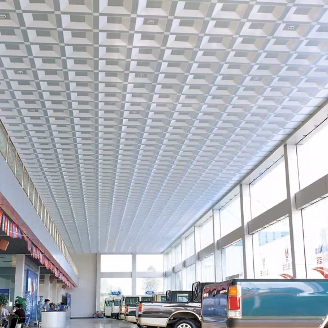 Combination ceiling of mixed panel sizes above a showroom floor