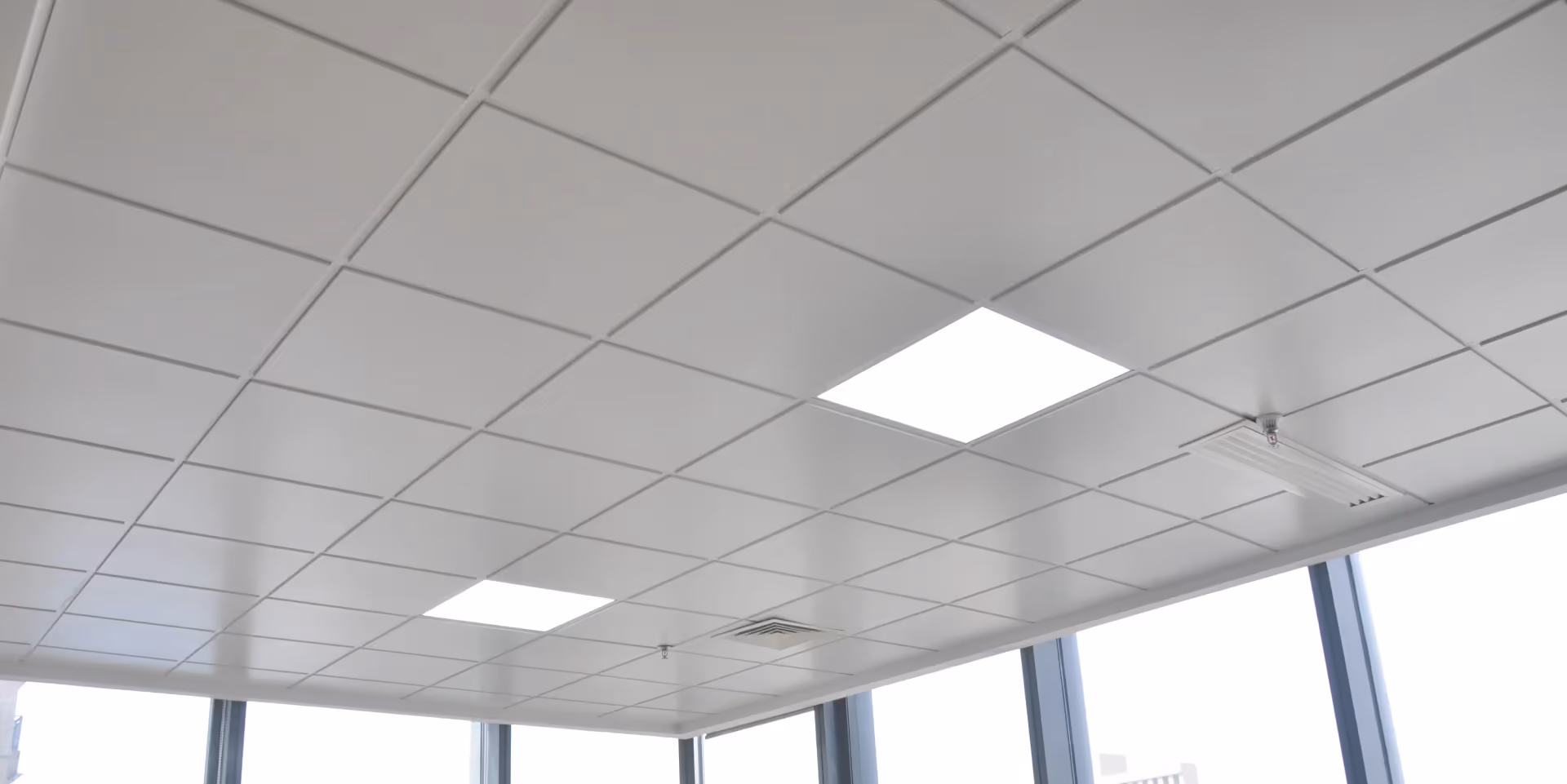 Exposed tee grid suspension system with panels laid in