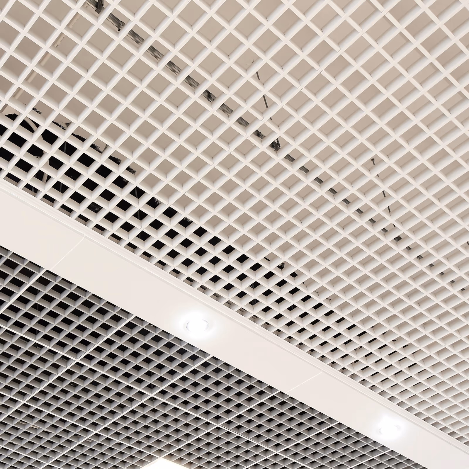 White open cell ceiling with linear lighting behind the grid