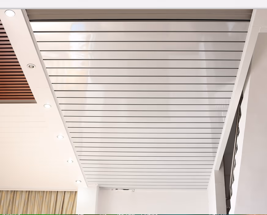 C-shaped strip ceiling panels meeting a wood-lined wall