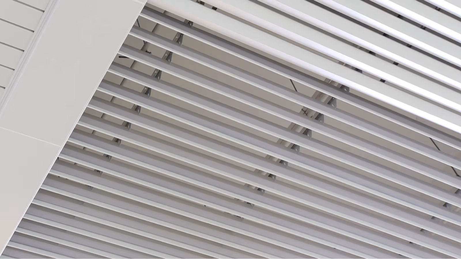 Strip ceiling turning down over an exposed soffit