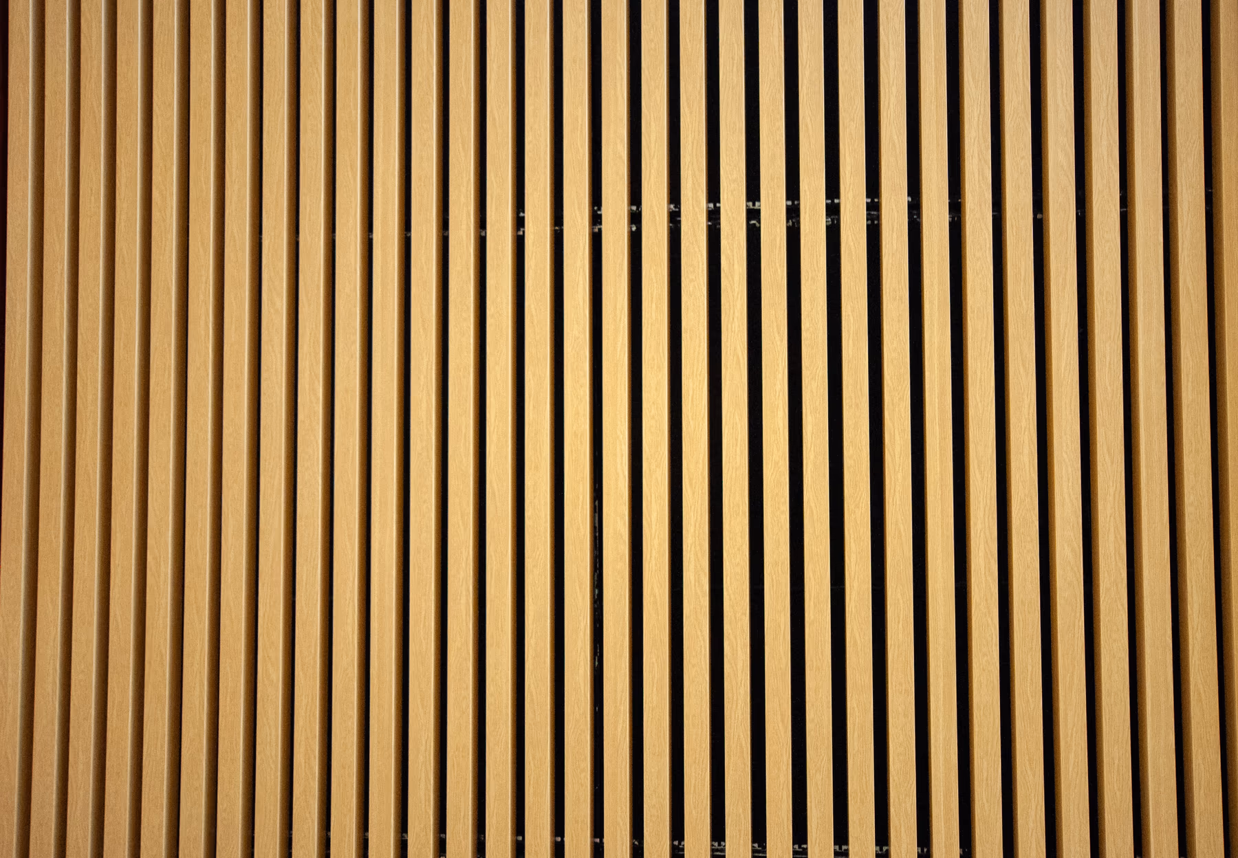 Extruded baffle ceiling over a bright open interior